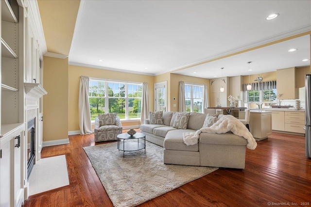 1 Osprey Commons S, Clinton, CT 06413 - living area featuring ornamental molding, plenty of natural light, dark wood-style floors, a fireplace with flush hearth, and recessed lighting