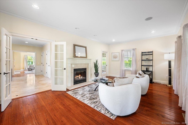 1 Osprey Commons S, Clinton, CT 06413 - living area with french doors, crown molding, wood finished floors, a fireplace, and healthy amount of natural light