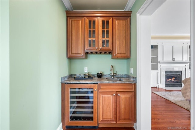 1 Osprey Commons S, Clinton, CT 06413 - indoor wet bar featuring wine cooler, a high end fireplace, wood finished floors, and ornamental molding