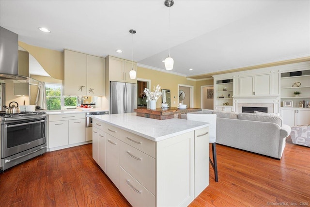 1 Osprey Commons S, Clinton, CT 06413 - kitchen with stainless steel appliances, crown molding, a center island, a breakfast bar area, and wood finished floors