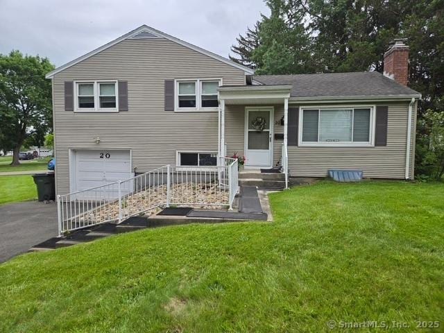 20 Kimball Rd, Wethersfield, CT 06109 - tri-level home featuring a garage, a chimney, driveway, and a front yard