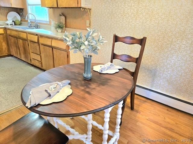 20 Kimball Rd, Wethersfield, CT 06109 - dining space featuring light wood-style floors and a baseboard heating unit