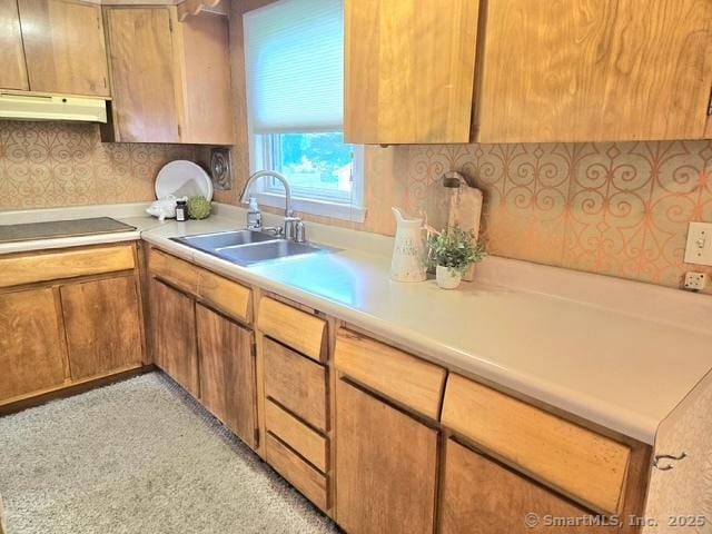 20 Kimball Rd, Wethersfield, CT 06109 - kitchen with under cabinet range hood, light countertops, black electric stovetop, and brown cabinets