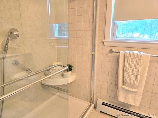 20 Kimball Rd, Wethersfield, CT 06109 - full bath with a baseboard heating unit, a stall shower, and tile walls