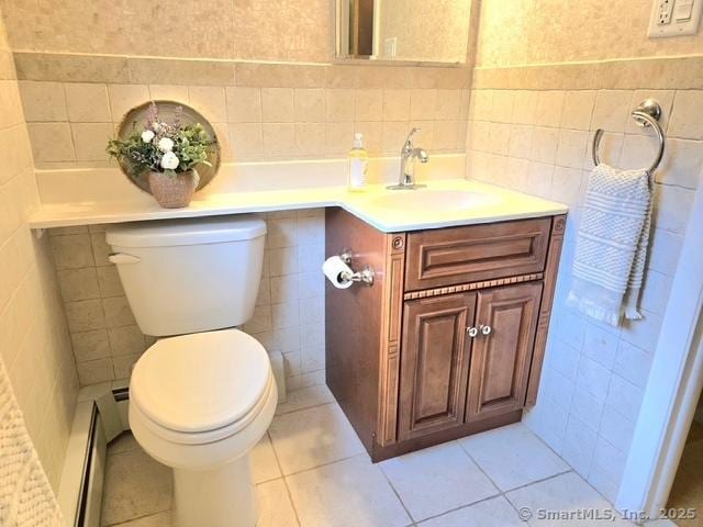 20 Kimball Rd, Wethersfield, CT 06109 - bathroom with tile walls, a baseboard radiator, vanity, and tile patterned floors