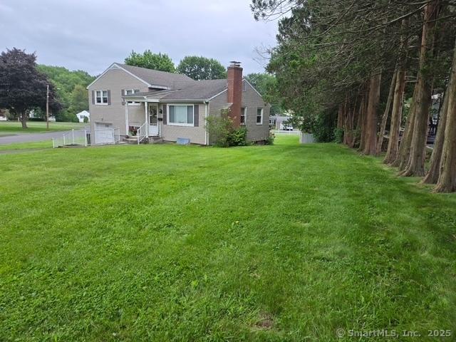 20 Kimball Rd, Wethersfield, CT 06109 - back of house with a chimney and a yard