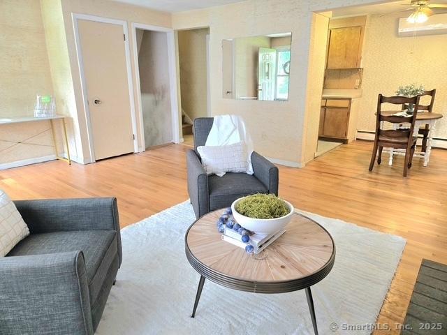 20 Kimball Rd, Wethersfield, CT 06109 - living room featuring light wood finished floors, stairway, and ceiling fan