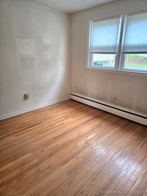 20 Kimball Rd, Wethersfield, CT 06109 - spare room with light wood-style floors and baseboard heating