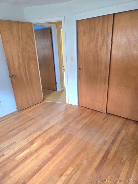 20 Kimball Rd, Wethersfield, CT 06109 - unfurnished bedroom with a closet and wood finished floors
