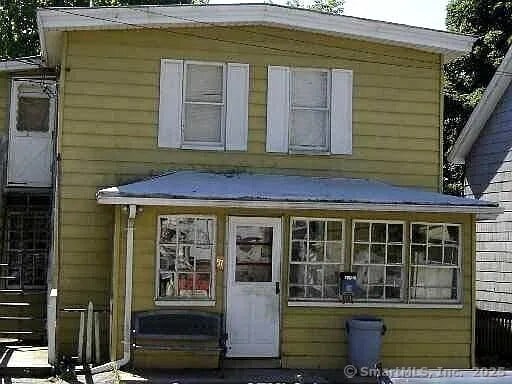 57 Chapman St, Windham, CT 06226 - rear view of house featuring a sunroom