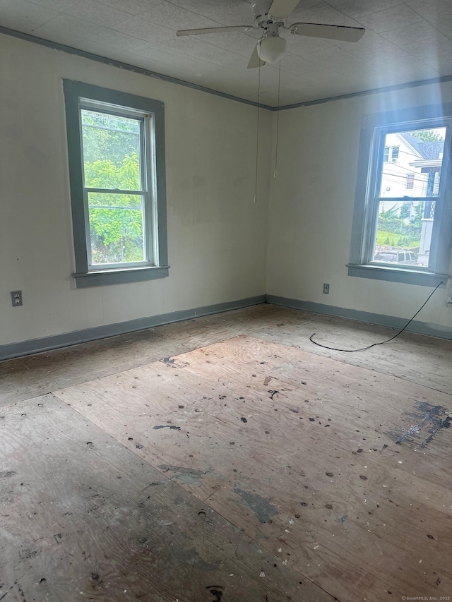 57 Chapman St, Windham, CT 06226 - empty room with plenty of natural light, baseboards, and a ceiling fan