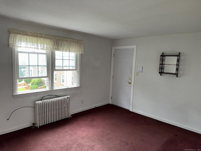 52 Robin Rd Apt B1, West Hartford, CT 06119 - spare room featuring radiator heating unit, dark carpet, and baseboards