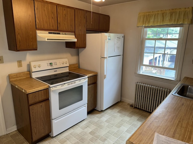 52 Robin Rd Apt B1, West Hartford, CT 06119 - kitchen with under cabinet range hood, radiator, white appliances, and baseboards
