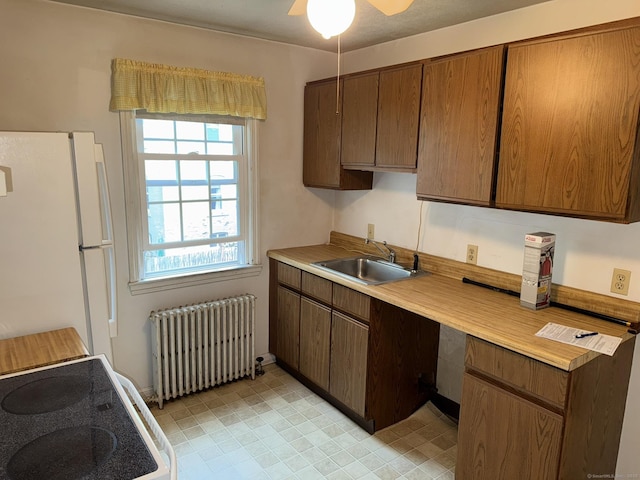 52 Robin Rd Apt B1, West Hartford, CT 06119 - kitchen with radiator heating unit, freestanding refrigerator, a sink, light countertops, and ceiling fan