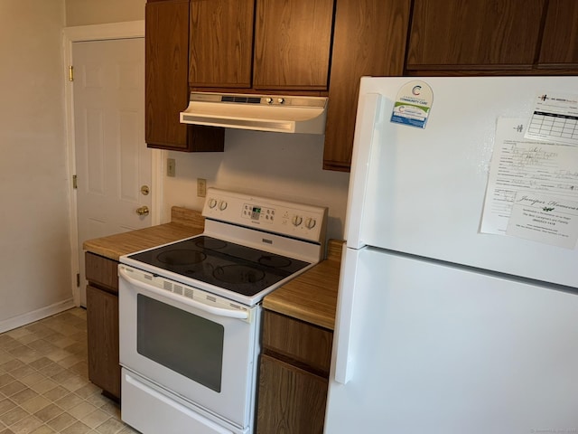 52 Robin Rd Apt B1, West Hartford, CT 06119 - kitchen with white appliances, under cabinet range hood, baseboards, and light countertops