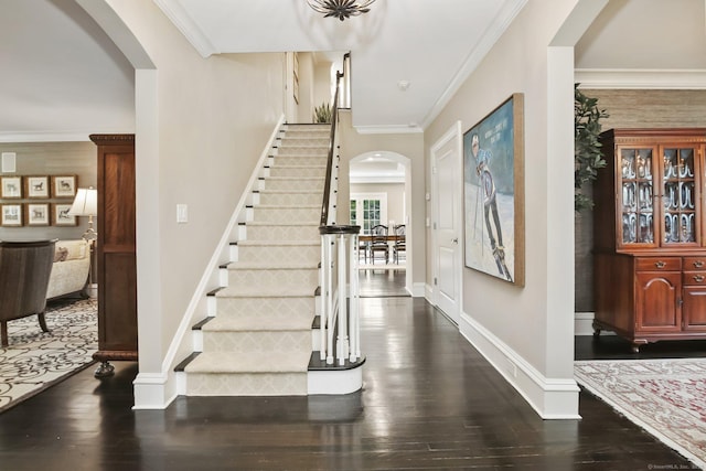 11 Old Hill Rd, Westport, CT 06880 - foyer entrance with arched walkways, stairway, dark wood-type flooring, and crown molding
