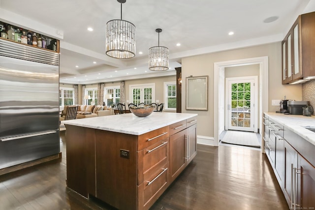 11 Old Hill Rd, Westport, CT 06880 - kitchen with built in refrigerator, light stone countertops, dark wood-style flooring, a center island, and recessed lighting