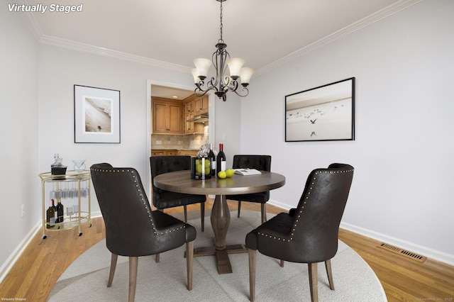 668 Glenbrook Rd Unit 9, Stamford, CT 06906 - dining room with ornamental molding, a chandelier, light wood-type flooring, and baseboards