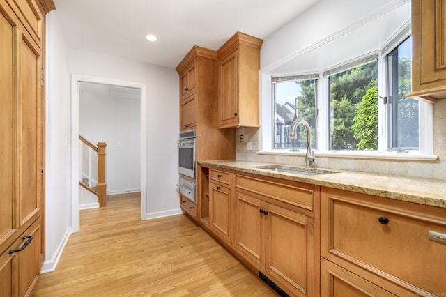 668 Glenbrook Rd Unit 9, Stamford, CT 06906 - kitchen with a sink, oven, tasteful backsplash, light wood-style floors, and light stone countertops