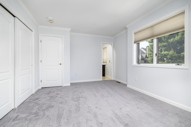 668 Glenbrook Rd Unit 9, Stamford, CT 06906 - unfurnished bedroom featuring ornamental molding, carpet, baseboards, and a closet