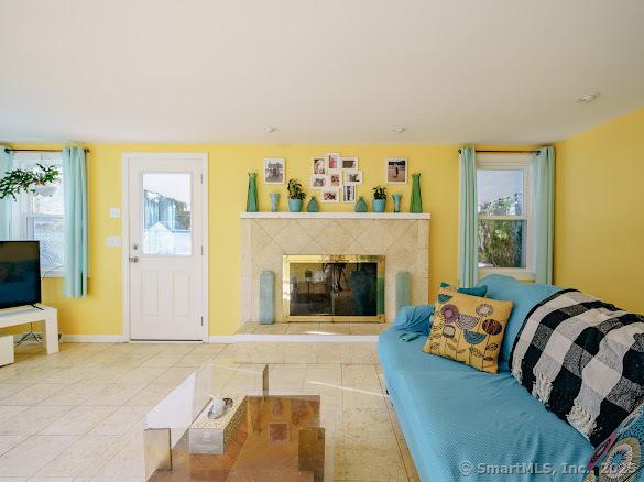 847 Glenbrook Rd, Orange, CT 06477 - living area featuring tile patterned flooring, a premium fireplace, and plenty of natural light