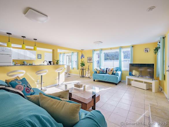 847 Glenbrook Rd, Orange, CT 06477 - living area with healthy amount of natural light and light tile patterned flooring