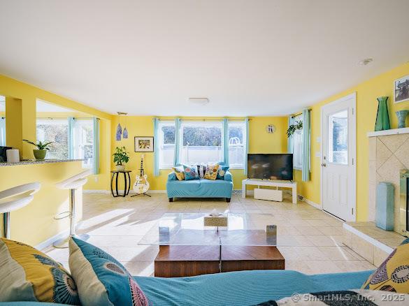 847 Glenbrook Rd, Orange, CT 06477 - living area with plenty of natural light, tile patterned floors, and a tile fireplace