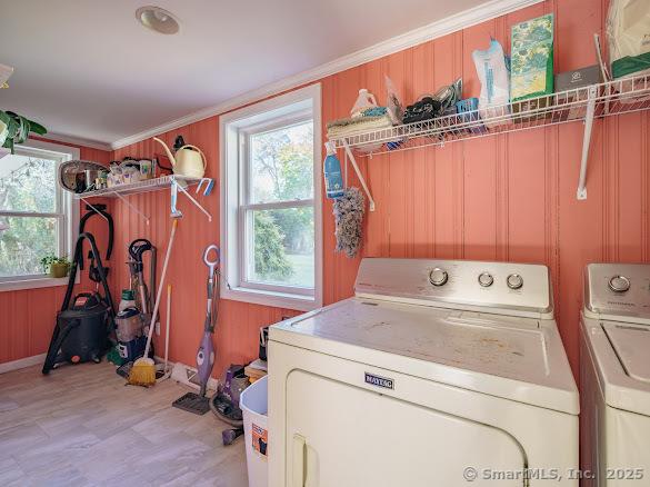 847 Glenbrook Rd, Orange, CT 06477 - washroom featuring plenty of natural light, washing machine and dryer, light floors, crown molding, and wood walls