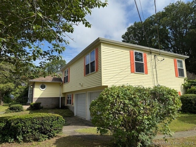 847 Glenbrook Rd, Orange, CT 06477 - view of side of home featuring a garage
