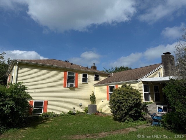 847 Glenbrook Rd, Orange, CT 06477 - rear view of property with a chimney, a yard, and cooling unit
