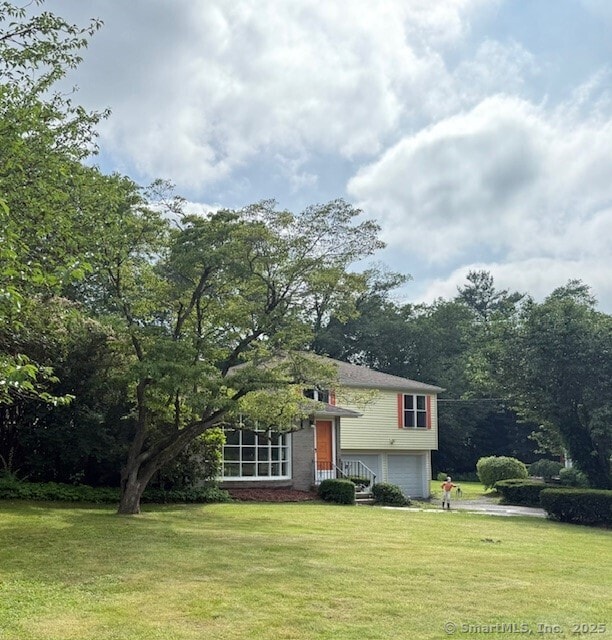 847 Glenbrook Rd, Orange, CT 06477 - tri-level home with a garage and a front lawn