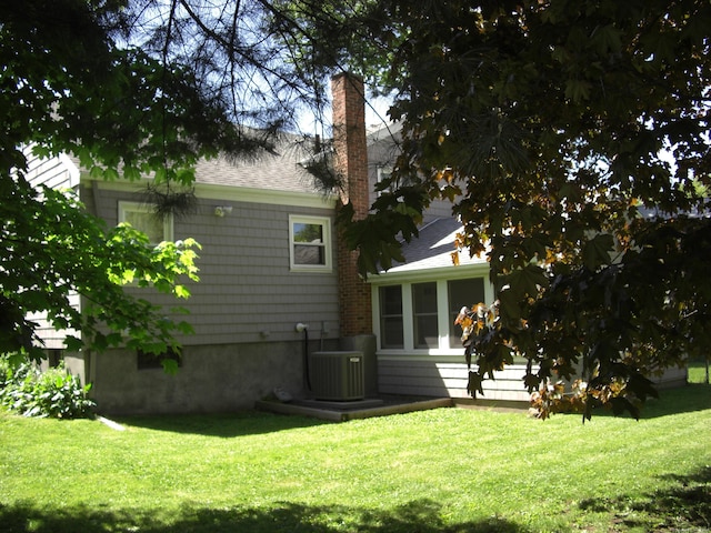 54 Bates St, Hartford, CT 06114 - rear view of house with a chimney, a yard, and roof with shingles
