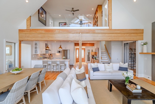 13 Seabreeze Pl, Norwalk, CT 06854 - living room featuring a high ceiling, light wood-style floors, stairs, a ceiling fan, and recessed lighting
