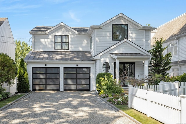 47 Pine Point Rd, Norwalk, CT 06853 - view of front of home featuring a standing seam roof, gravel driveway, a garage, and a metal roof