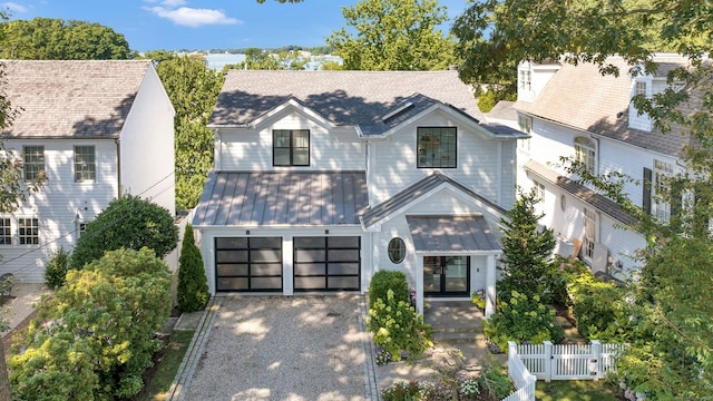 47 Pine Point Rd, Norwalk, CT 06853 - view of front facade featuring a standing seam roof, gravel driveway, a metal roof, and a garage