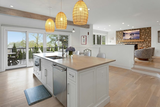 47 Pine Point Rd, Norwalk, CT 06853 - kitchen with appliances with stainless steel finishes, light wood-type flooring, recessed lighting, decorative light fixtures, and white cabinets