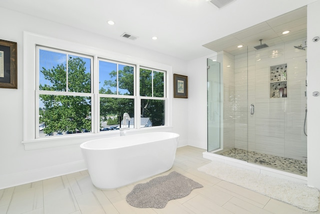 47 Pine Point Rd, Norwalk, CT 06853 - bathroom with healthy amount of natural light, a stall shower, a freestanding bath, and recessed lighting