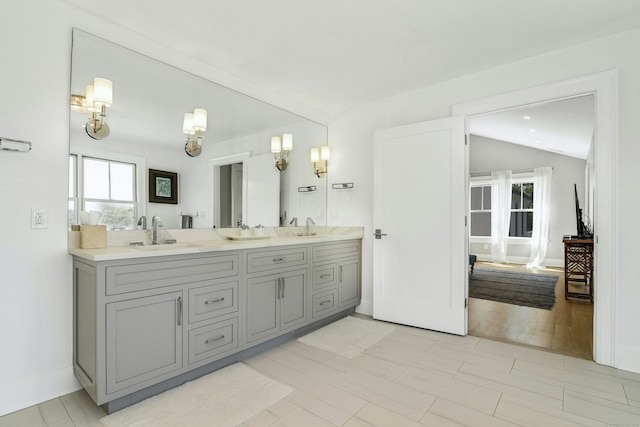 47 Pine Point Rd, Norwalk, CT 06853 - bathroom featuring double vanity, plenty of natural light, and vaulted ceiling