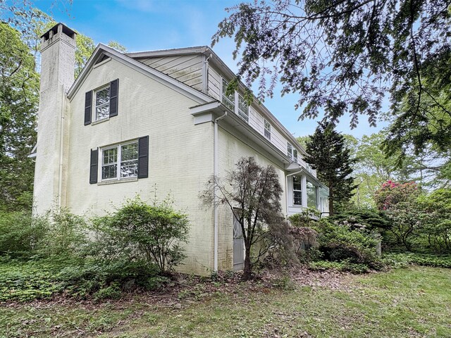 206 Peddlers Rd, Guilford, CT 06437 - view of home's exterior with a chimney and brick siding