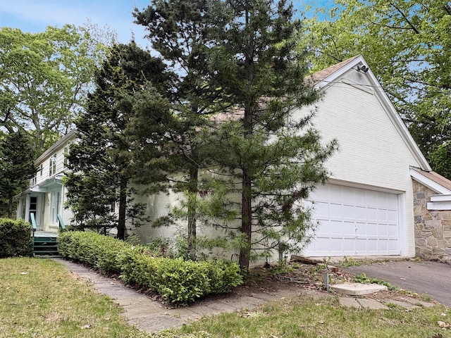 206 Peddlers Rd, Guilford, CT 06437 - view of home's exterior with a garage, asphalt driveway, and stone siding