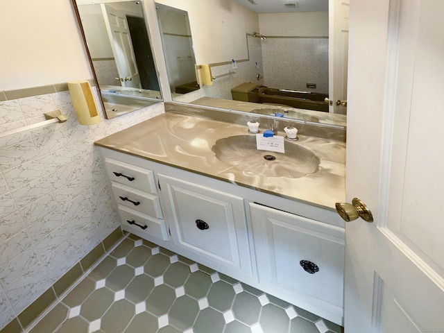 206 Peddlers Rd, Guilford, CT 06437 - bathroom featuring vanity, tile walls, tile patterned flooring, and a shower
