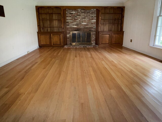 206 Peddlers Rd, Guilford, CT 06437 - unfurnished living room featuring light wood-style flooring, a fireplace, and baseboards
