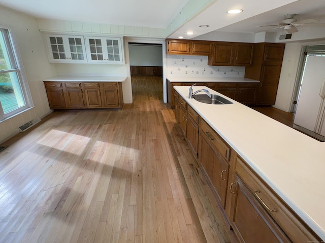206 Peddlers Rd, Guilford, CT 06437 - kitchen with a sink, light wood-type flooring, brown cabinets, light countertops, and recessed lighting
