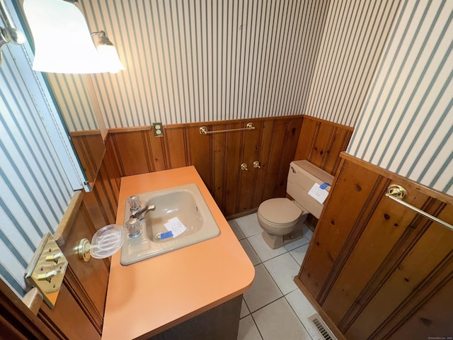 206 Peddlers Rd, Guilford, CT 06437 - bathroom with wallpapered walls, a wainscoted wall, toilet, a sink, and tile patterned floors