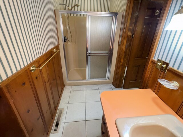 206 Peddlers Rd, Guilford, CT 06437 - bathroom featuring wallpapered walls, a stall shower, a sink, and tile patterned flooring