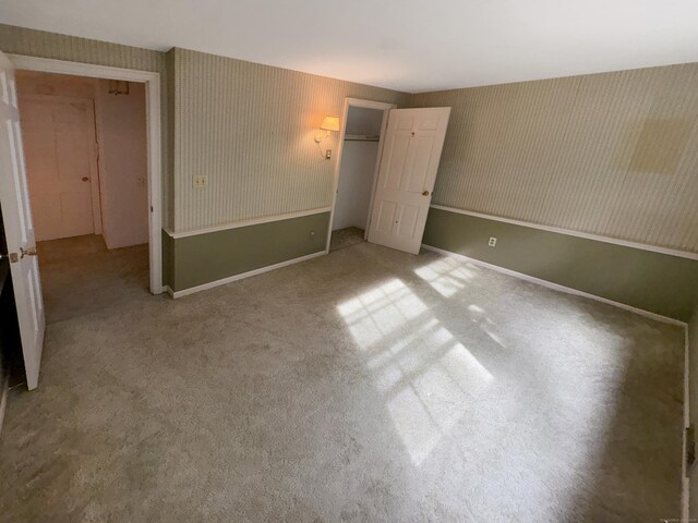 206 Peddlers Rd, Guilford, CT 06437 - unfurnished bedroom featuring wallpapered walls, carpet floors, baseboards, and a closet