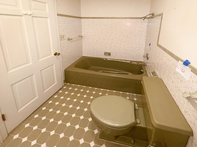 206 Peddlers Rd, Guilford, CT 06437 - full bath with a tub to relax in, tile walls, wainscoting, toilet, and tile patterned floors