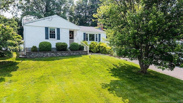 60 Davenport Rd, West Hartford, CT 06110 - view of front of house featuring a chimney, a front yard, and brick siding