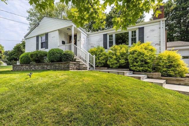 60 Davenport Rd, West Hartford, CT 06110 - view of front of property with a front lawn, a chimney, and brick siding