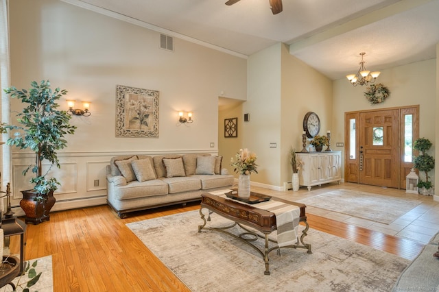 425 Pattonwood Dr, Southington, CT 06489 - living area featuring a high ceiling, a chandelier, light wood finished floors, ceiling fan, and crown molding